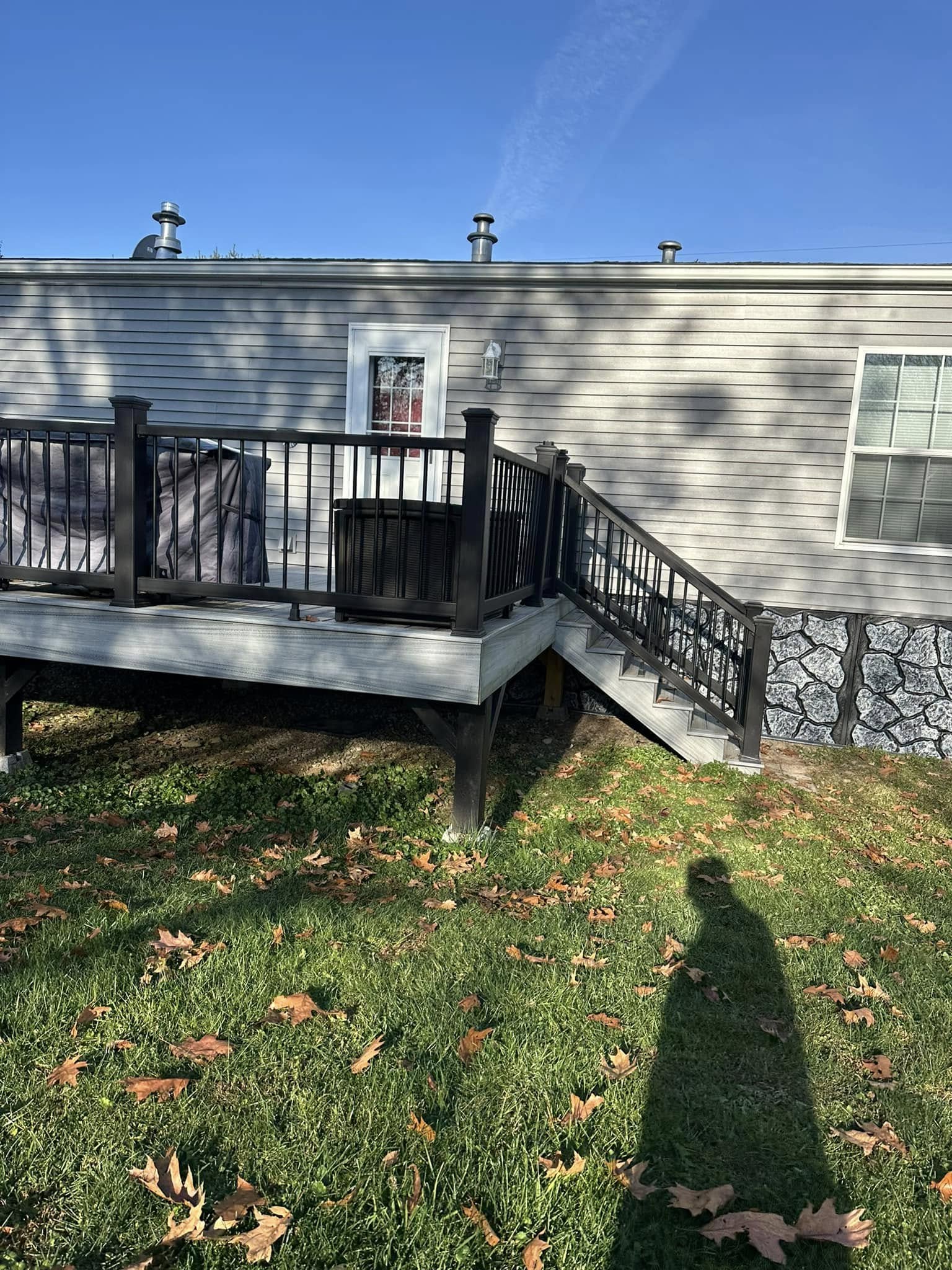 Gray composite deck with black aluminum railings.