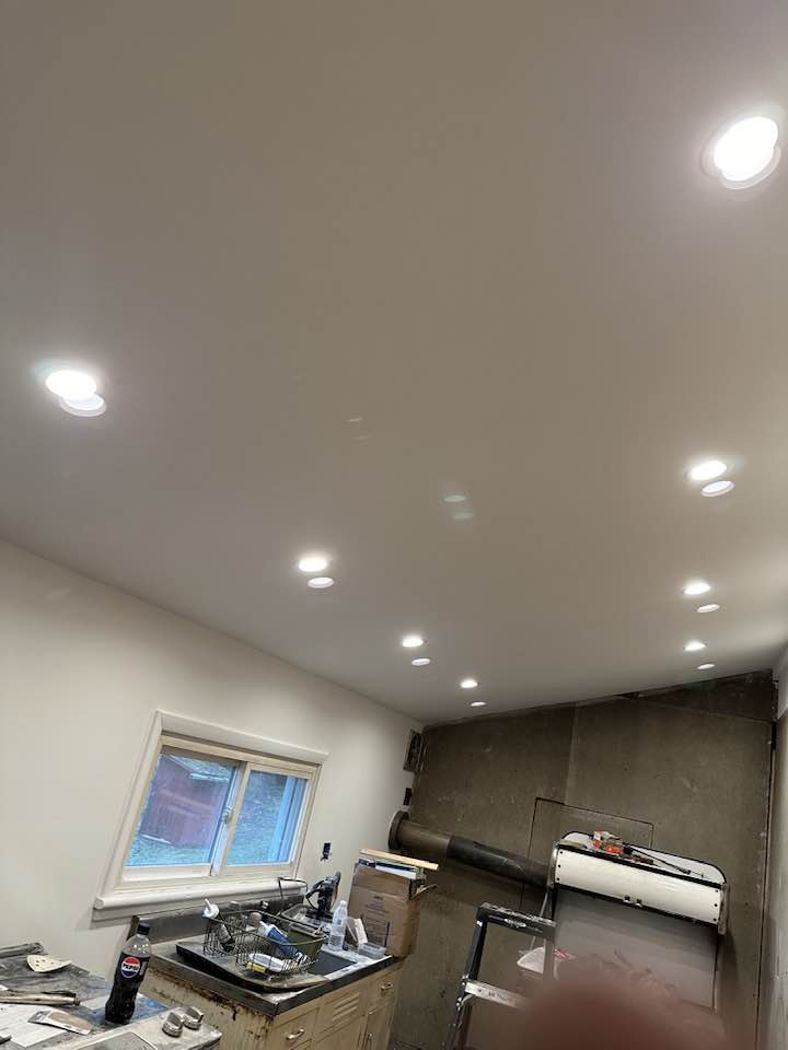 Professional drywall installation with smooth finish in a residential living room.