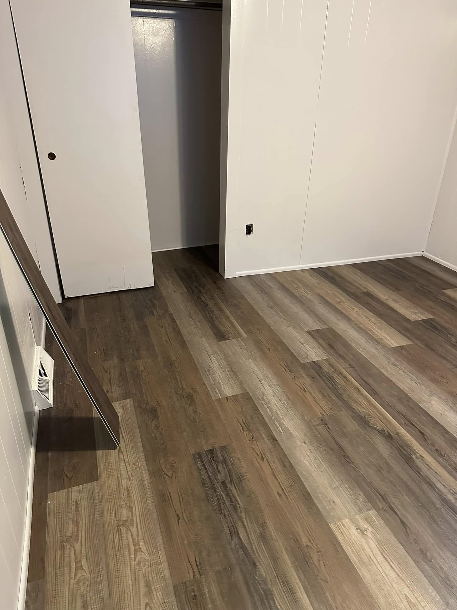 Luxury vinyl plank flooring installation in living room.