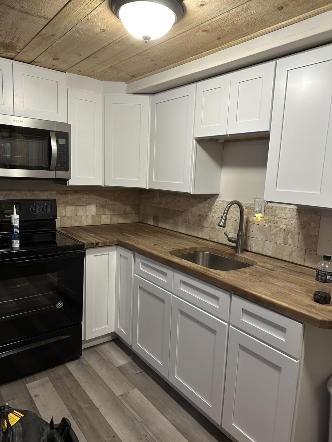 Modern kitchen remodel with white shaker cabinets.